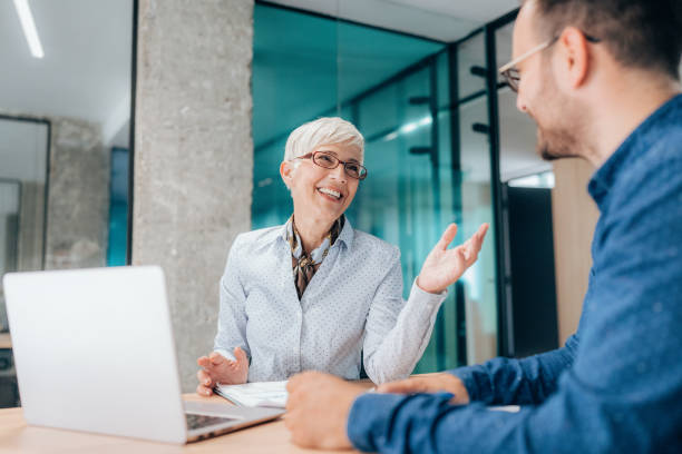 istock Two business people working together in office 1401103648