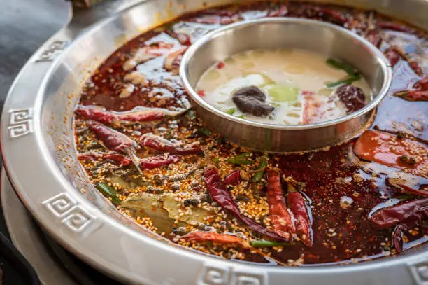 Hotpot is an interactive meal in which diners sit around a simmering pot of soup at the center of the table with ingredients.
