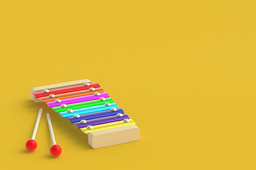 Xylophone isolated on yellow background. Kids toy. Preschool education. Musical instrument. Funny laisure. Copy space. 3d render