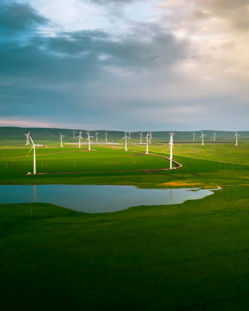 istock Wind turbine farm at sunset with dramatic sky. Producing alernative energy. Renewable energy concept. 1401113852