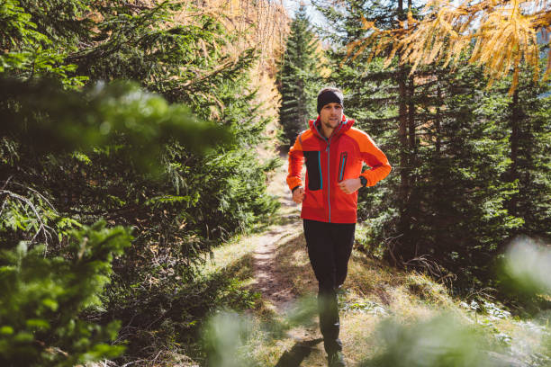 Free Stock Photo of Male athletic runner in a red jacket with a hood ...