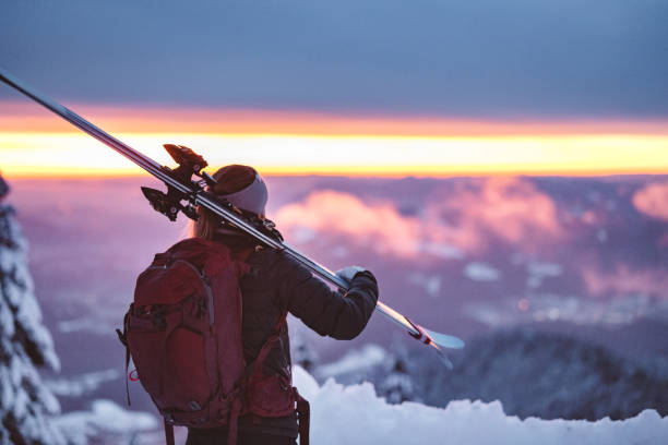 istock Ski tourer watching the sun go down - Pink winter sunset 1401114436