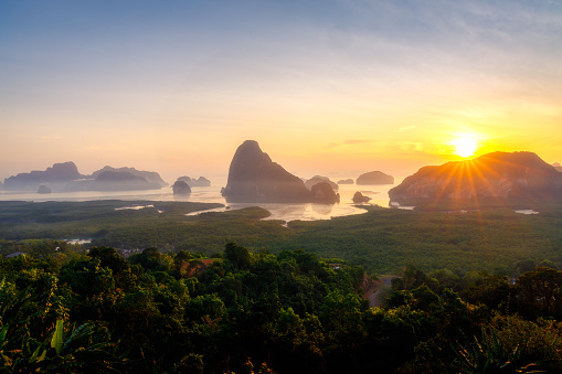 Sunrise at at Samed Nang Chee viewpoint, Pang nga, Thailand. Seascape in morning with yellow and orange sky.