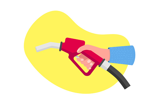 Hand holding a red fuel pump. Holding fuel nozzle. Gas for automobile.
