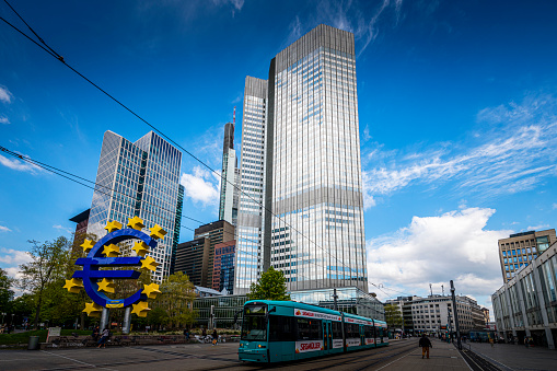 Frankfurt, Germany - April, 21. 2022: until 2015 the former European Central Bank with Euro symbol and skyline of Frankfurt in Germany.