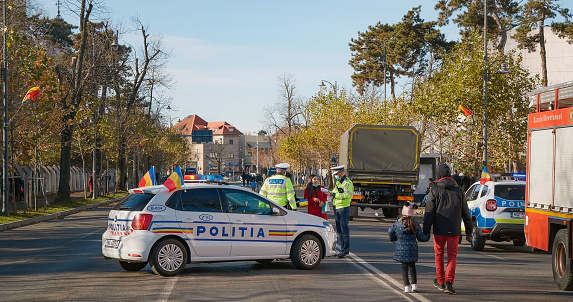 Bucharest, Romania - 1 December, 2021: Romanian police car, police man, people. Romania National Day.