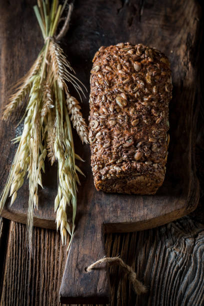 istock Rustic loaf of bread with grains with ears of wheat 1401120280
