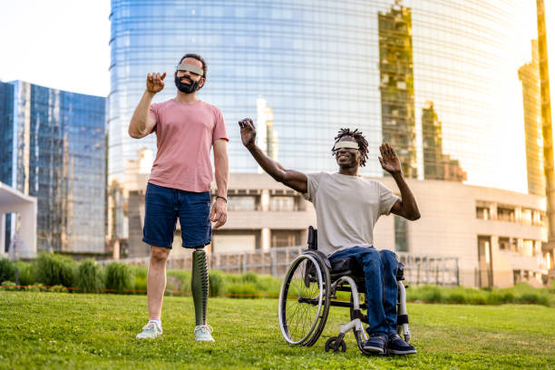 istock two friends who have a different disability using modern technology headsets, trying virtual reality outdoors, modern skyscrapers as background 1401124170
