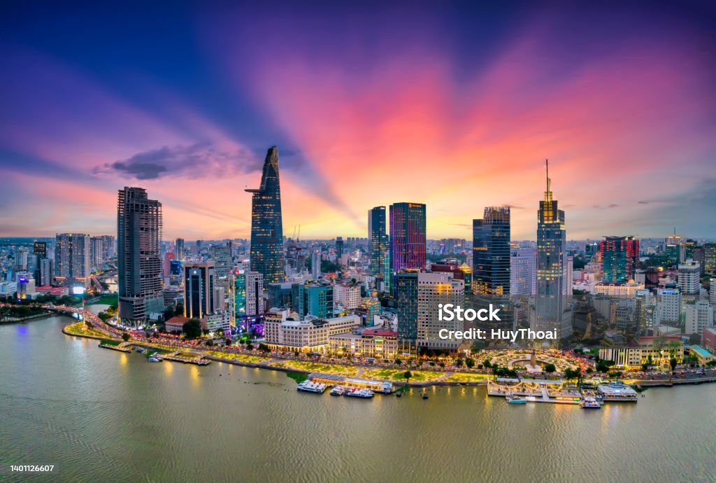 Aerial view of beautiful skyscrapers along the river at sunset sky Aerial view of beautiful skyscrapers along the river at sunset sky light flowing down urban development in Ho Chi Minh City, Vietnam. Ho Chi Minh City Stock Photo