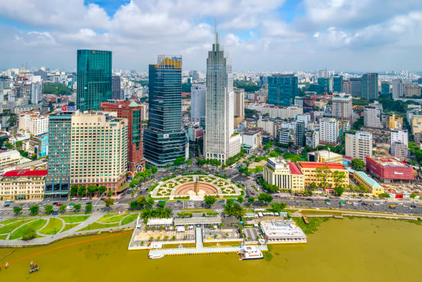 Top view aerial photo from flying drone of a Ho Chi Minh City, Vietnam Top view aerial photo from flying drone of a Ho Chi Minh City with development buildings, transportation, energy power infrastructure. Financial and business centers in developed Vietnam panoramic riverbank architecture construction site stock pictures, royalty-free photos & images