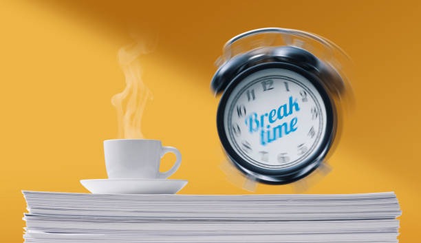 istock Coffee and alarm clock on a pile of paperwork 1401128014