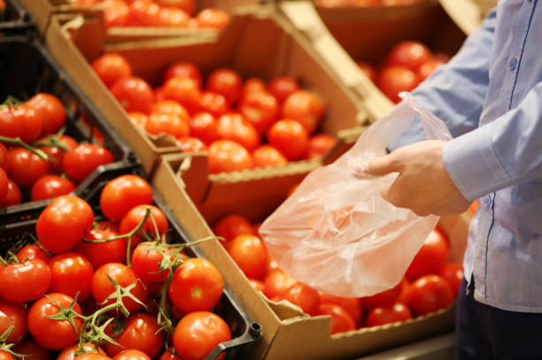 istock buying tomatoes at the market 1401128270