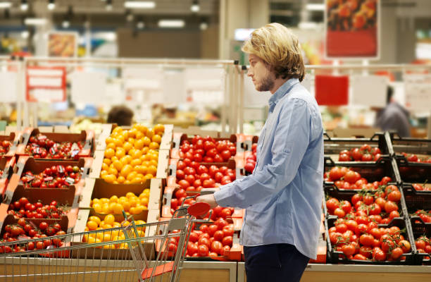 istock buying tomatoes at the market 1401128271