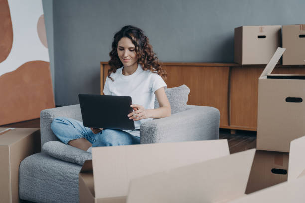 istock Happy lady is sitting in armchair and working with pc. Delivery service ordering through internet. 1401129372