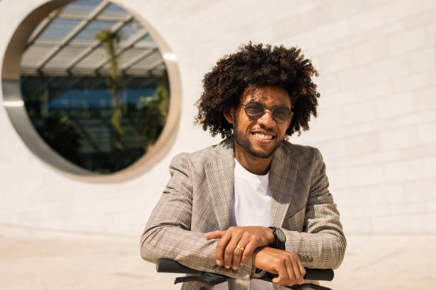 istock Attractive African American man riding electric scooter 1401129563