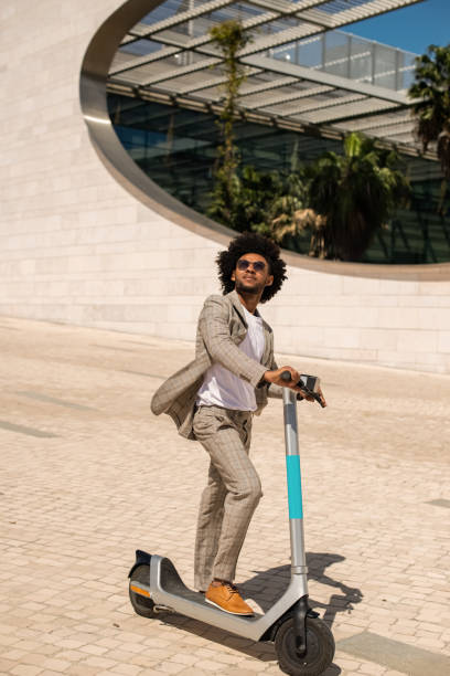 istock Happy African American man riding electric scooter 1401129655