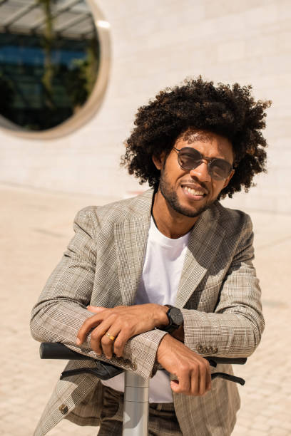 istock Good-looking African American man riding electric scooter 1401129711