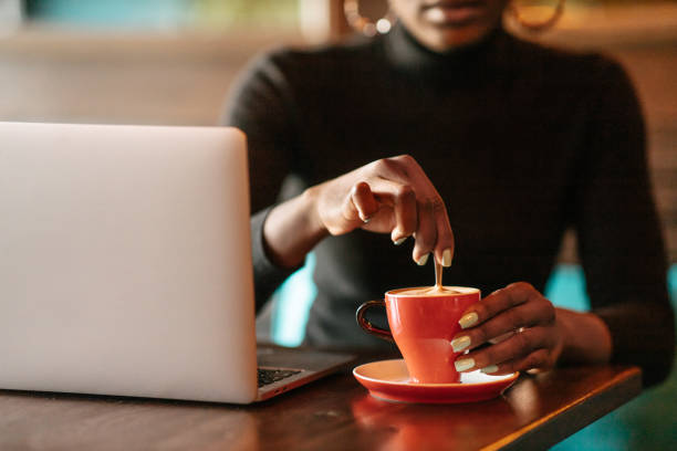 African woman stirring coffee