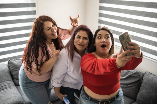 istock Friends taking a selfie or filming on smartphone at home 1401136096