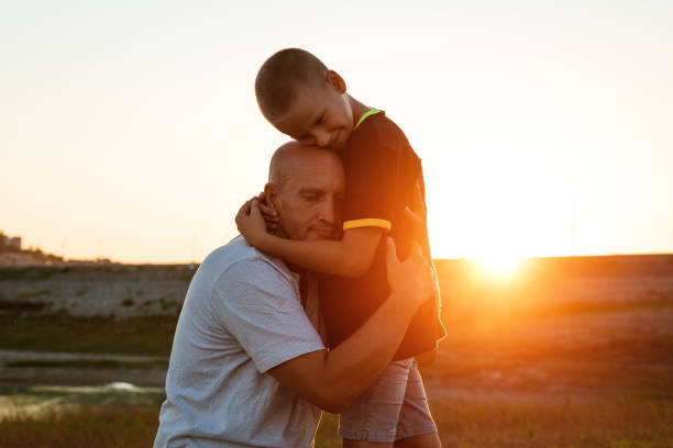 istock Son and dad standing against the backdrop of a colorful 1401136174