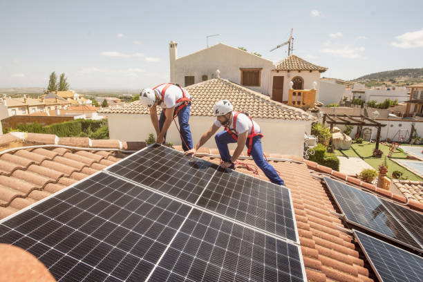 Installation of solar panels on the roof of a house, maintenance and cleaning with vertical works stock photo