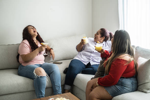 istock Friends talking and drinking at home 1401136270