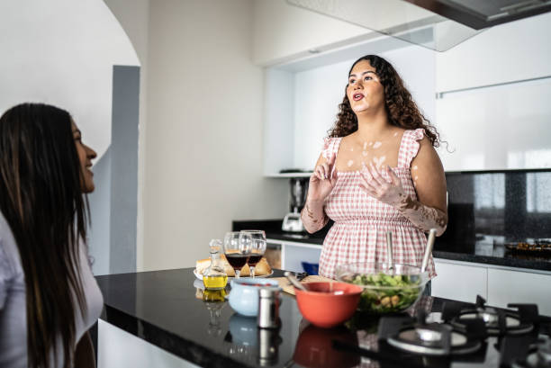 istock Young woman talking with a friend at home 1401136430