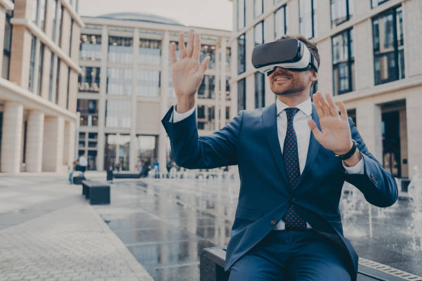 istock Successful young businessman in formal suit viewing future project in virtual reality 1401136434