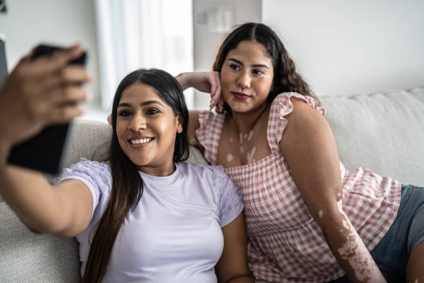 istock Friends taking selfie or filming using mobile phone at home 1401137395