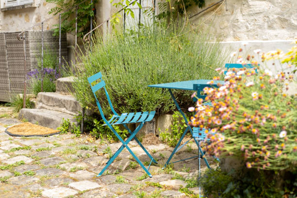 istock Blue chair and table in front of an old abandoned rustic house. 1401137471