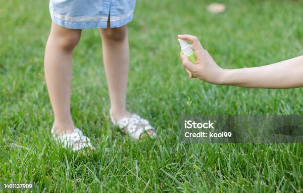 Mother Sprays Mosquito Repellent For Daughter Stock Photo - Download Image Now - Mosquito, Insect Repellant, Child