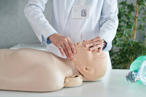 istock Doctor demonstrating artificial respiration on mannequin 1401137910