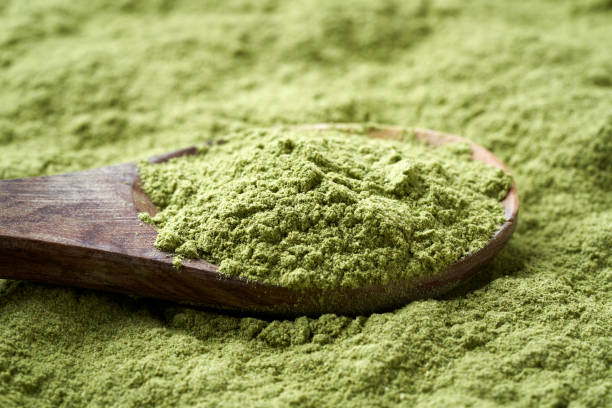 istock Barley grass powder on a wooden spoon 1401138013