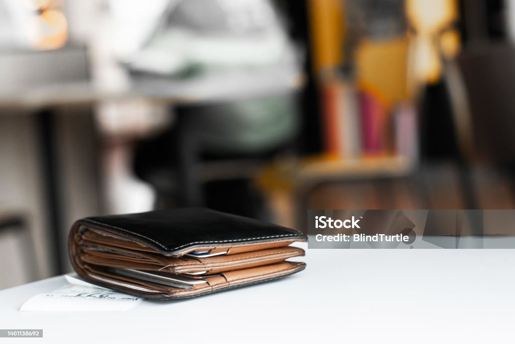 Money and credit card in a leather wallet Soft tone of Money and credit card in a leather wallet on wooden table and bill slip background Business Stock Photo