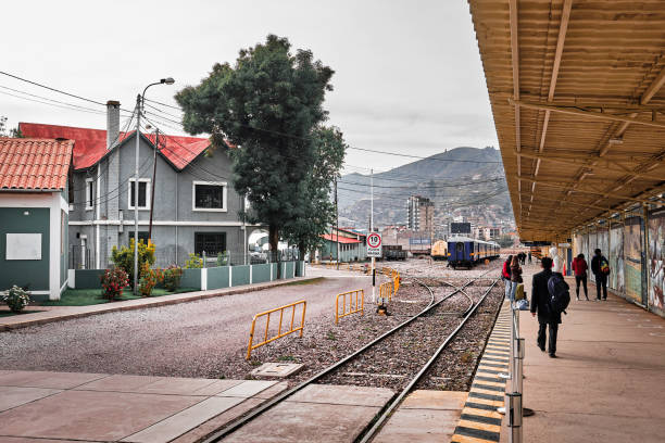 Cusco, Peru - January 04, 2022: Railway station with passengers on the platform.