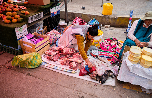 Puno, Peru - January 09, 2022: Locals sell llama meat at a street market in the city.