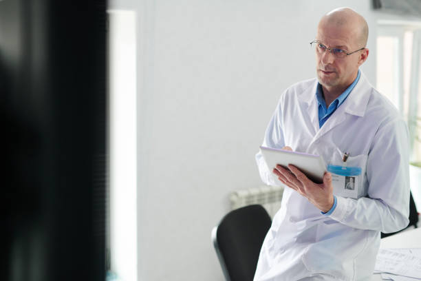 istock Mature male doctor having online conference 1401144341