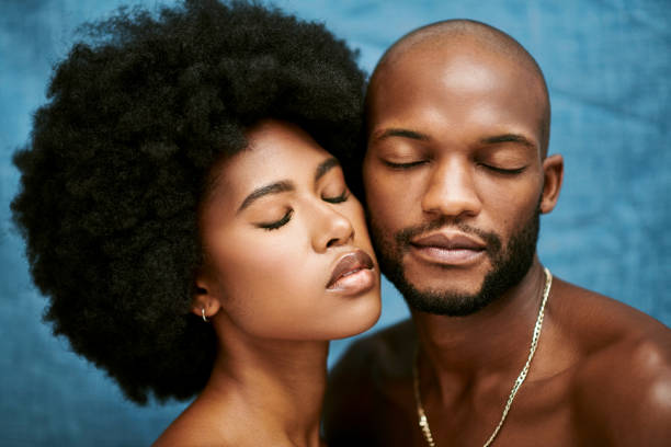 Face closeup of two people with perfect, glowing skin standing against a blue background. Headshot of a male and female model standing with their eyes closed, promoting clear skin Face closeup of two people with perfect, glowing skin standing against a blue background. Headshot of a male and female model standing with their eyes closed, promoting clear skin couple isolated wife husband stock pictures, royalty-free photos & images