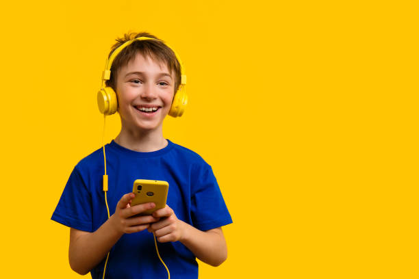 istock Boy with Headphones Using Smartphone 1401144954