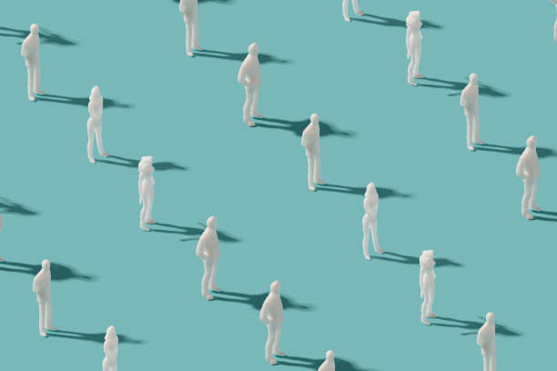 istock Plastic human figurines arranged on a pastel blue background. 1401145807