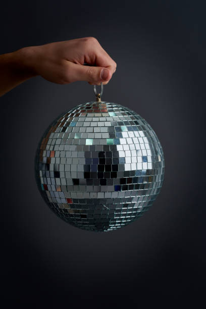 istock Man holding a disco ball, old school party concept 1401147117