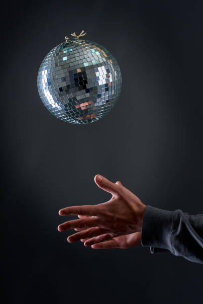 istock A disco ball levitating above a man's hand, old school party concept 1401147140