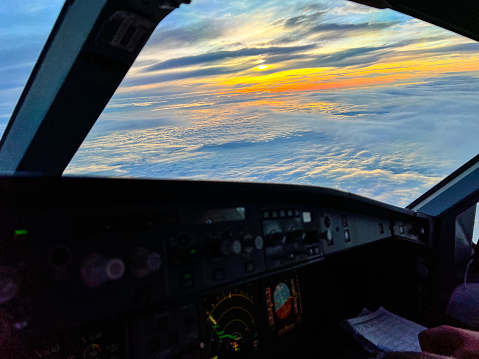 airplane part of cockpit view at sunrise