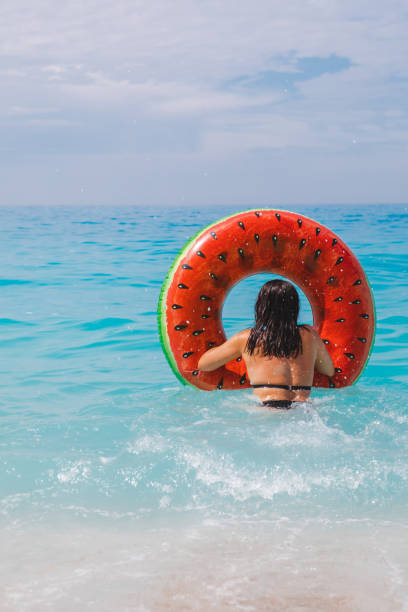 istock woman going to swim with inflatable ring 1401148191