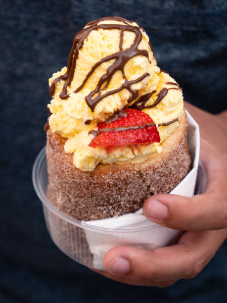 Trdelnik Czech Spit Cake with Vanilla Ice Cream Trdelnik, also called trdlo or trozkol, a Czech Spit Cake with Vanilla Ice Cream, Chocoolate Sauce and Strawberry trdelník stock pictures, royalty-free photos & images