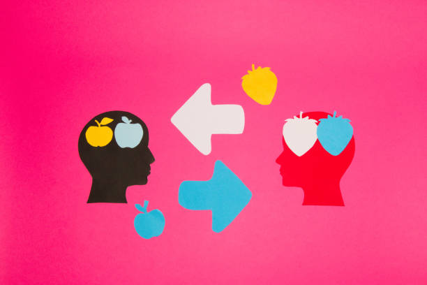 istock black and red paper head with a brain of fruit that symbolizes knowledge, two heads exchange knowledge and improve each other, creative art design on the pink background 1401149584