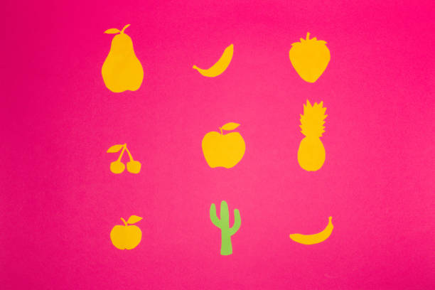 yellow paper fruit and one green cactus on a pink background, break the pattern, creative summer design, minimal concept