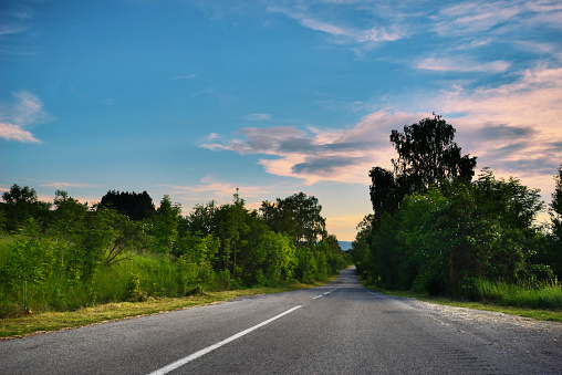 Low angle view of an empty road an cloudy sky.