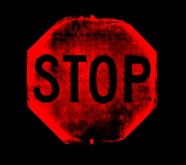 Painted stop sign on asphalt road, parking lot.