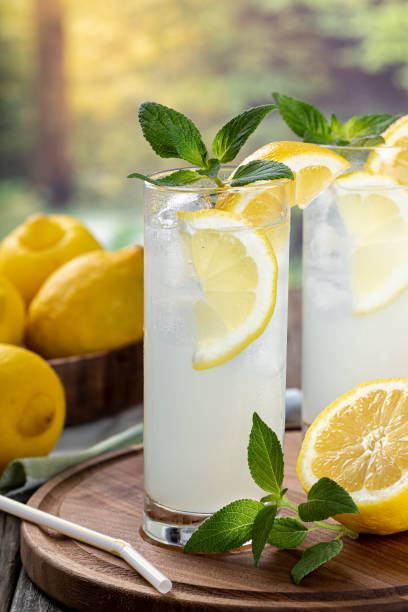 istock Two glasses of cold lemonade with rural background 1401150806